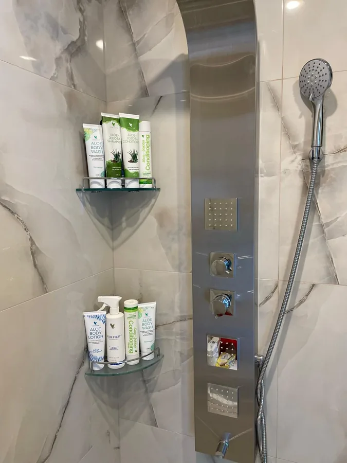 Premium Forever toiletries in the shower — bathroom amenity detail